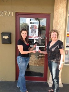 Putting up NLAAD flyers. Photo courtesy of the Latino Commission on AIDS.